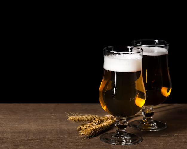 Two glasses of beer on a black background