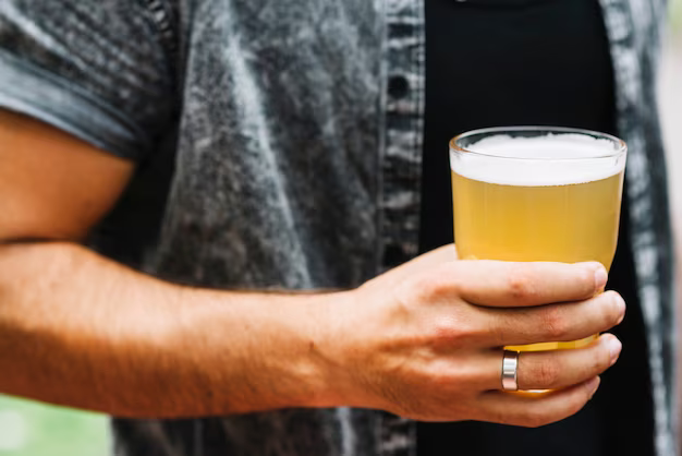 Man holding a glass of beer in his hand